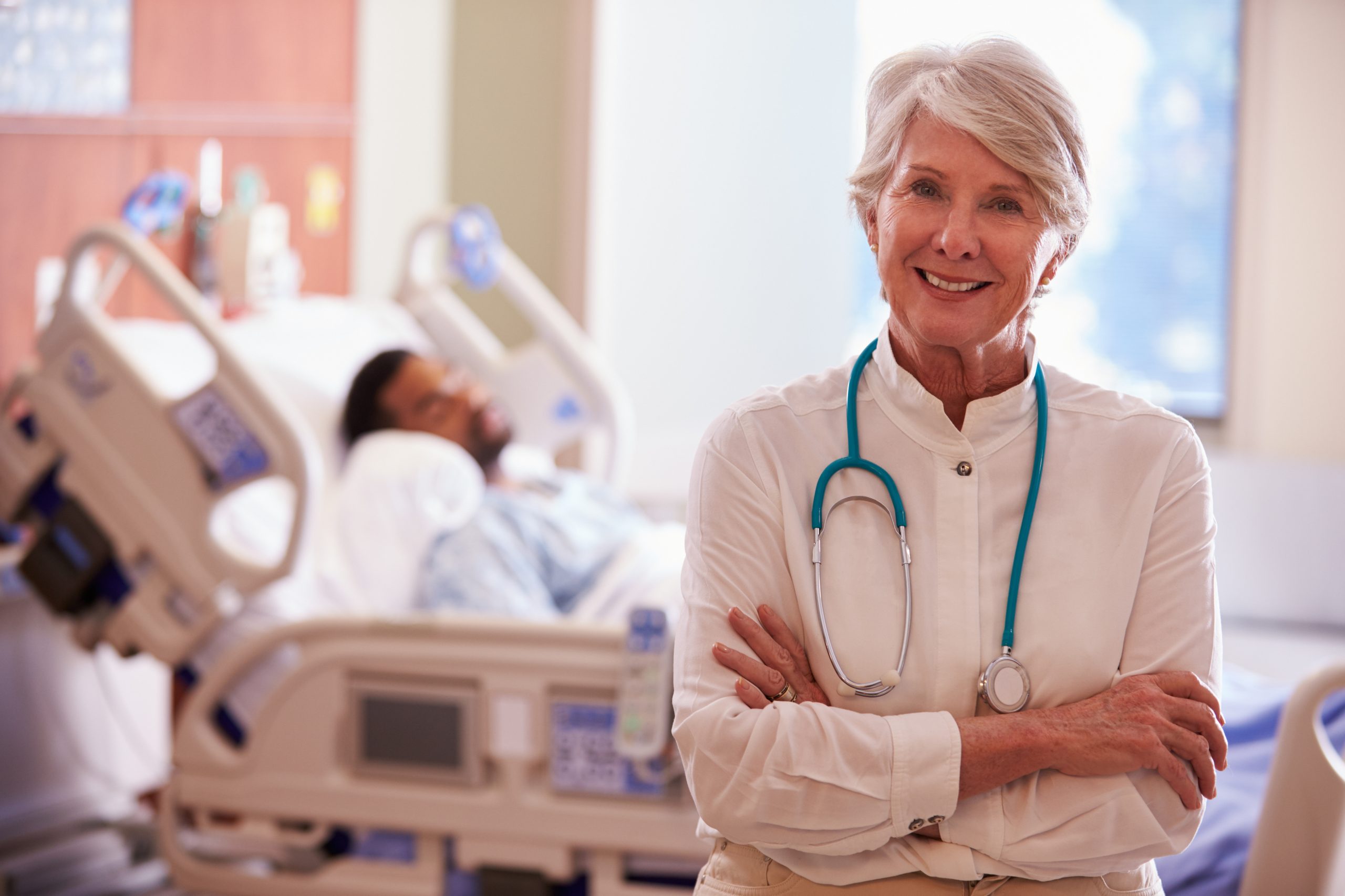 Portrait Of Female Doctor With Patient In Background